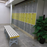Tali Sport plastic changing room bench with white and yellow slats in a gym locker room setting. 