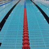 Tali Sport swimming pool lane divider with red and blue polyethylene floats installed in an indoor competition pool 