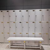 Tali Sport white plastic changing room bench in front of a wall of lockers for gyms and swimming pools 