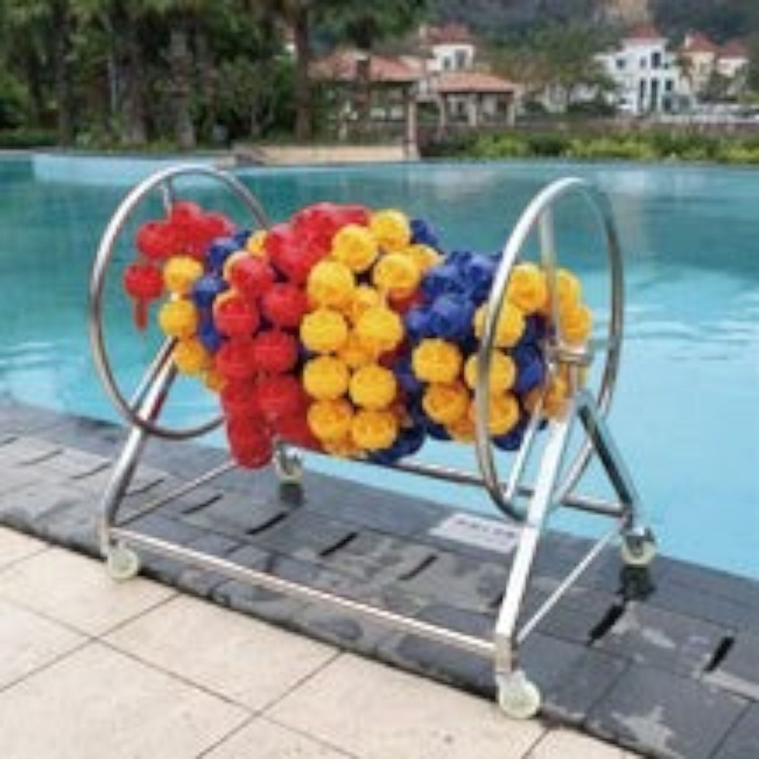 Tali Sport swimming pool lane rope with colorful hexagonal floats on a stainless steel storage reel by the pool-12/12 
