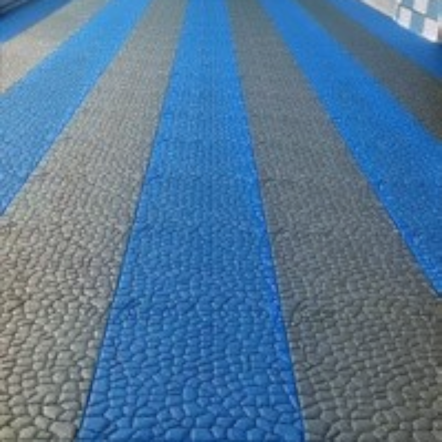 Tali Sport modular anti-slip PVC pool flooring tiles in blue and grey installed on a swimming pool deck-10/14 