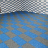 Tali Sport modular anti-slip PVC floor tiles in a blue and grey checkered pattern for pool and shower areas 