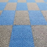 Tali Sport modular anti-slip PVC pool tiles in a blue and grey checkered pattern for wet areas and locker rooms 