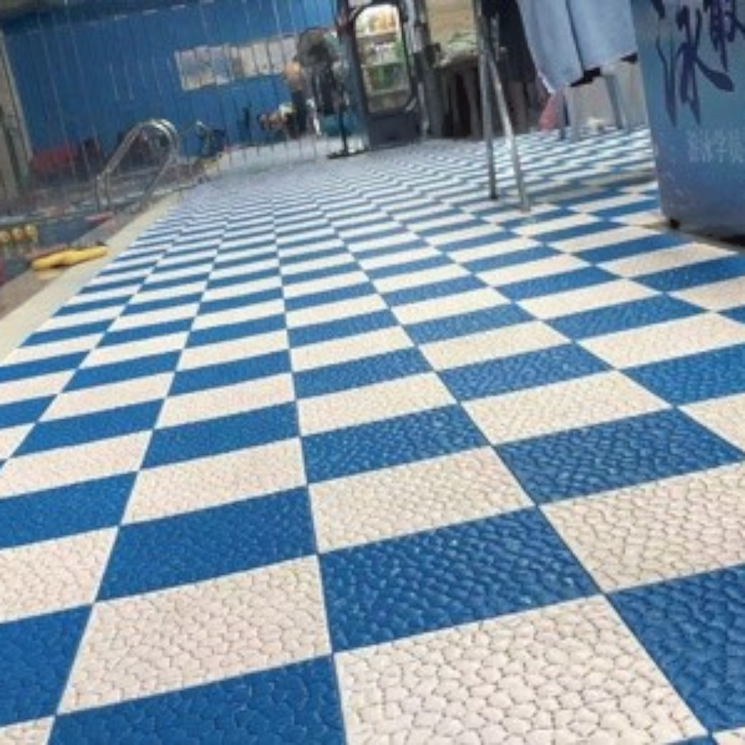 Tali Sport modular blue and white anti-slip PVC floor tiles installed around a swimming pool deck-14/14 